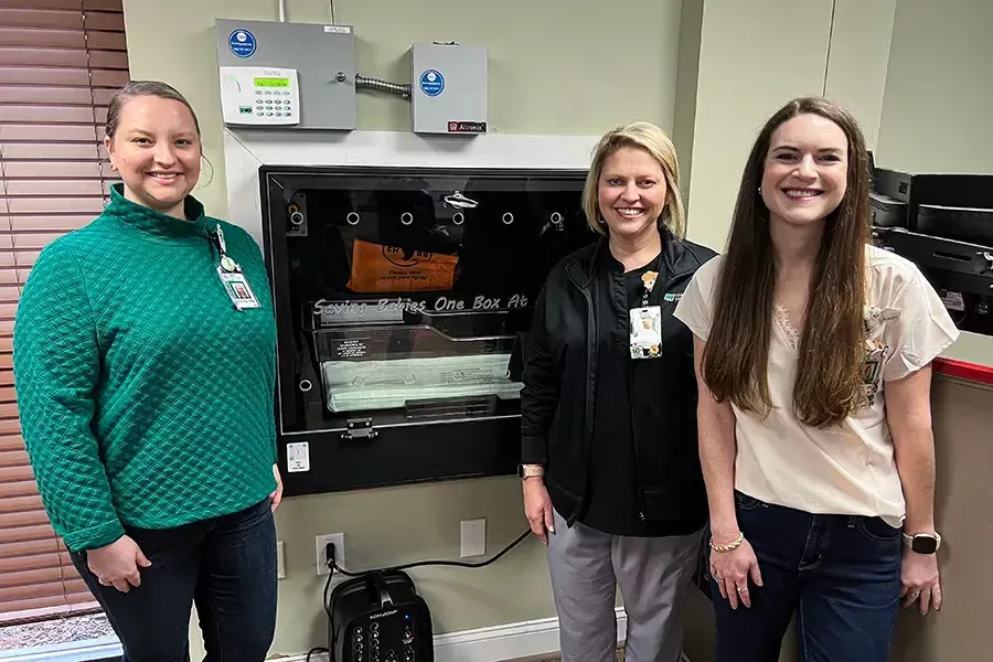 Members of the Madison Hospital Nursery team pictured with the Safe Haven Baby Box from the inside of the fire station